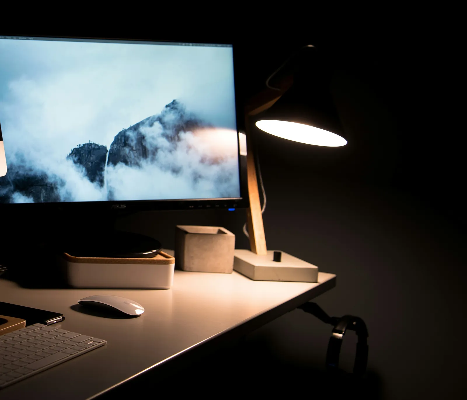 A focused workspace lit at night.