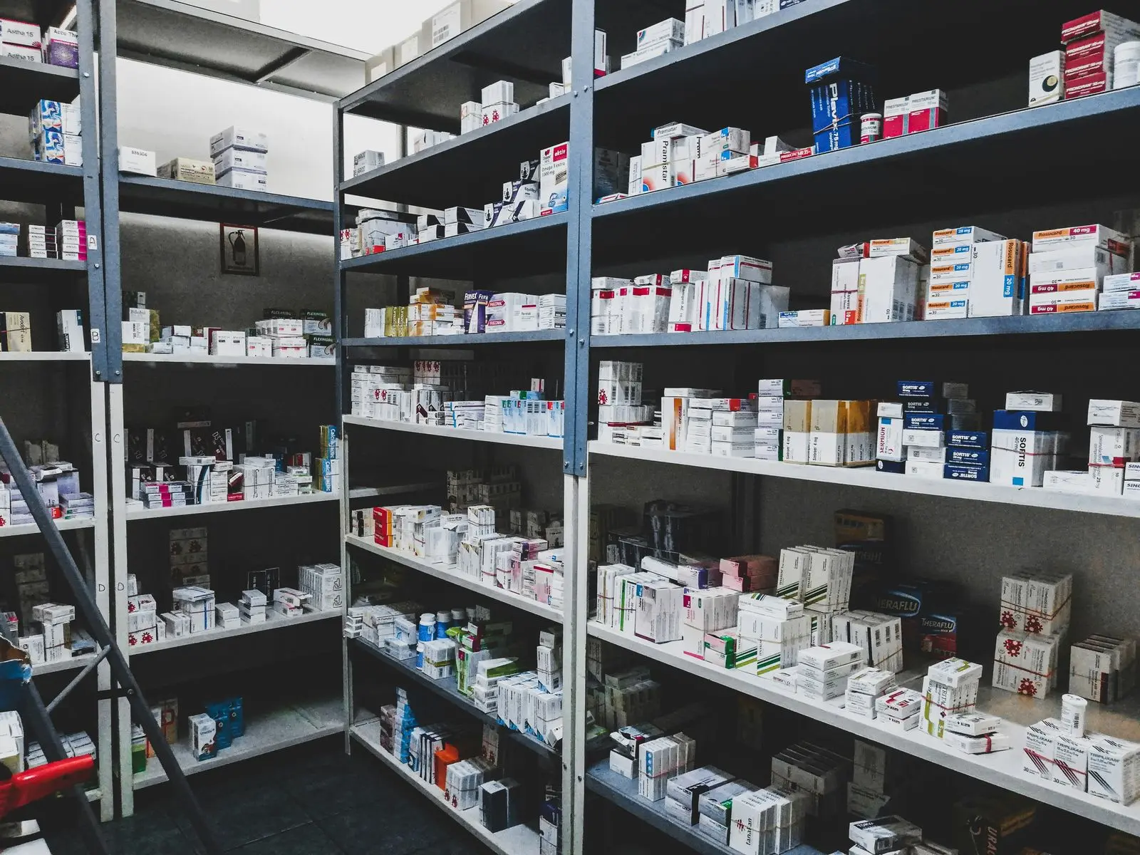 Shelves of packaged medicines inside a pharmacy